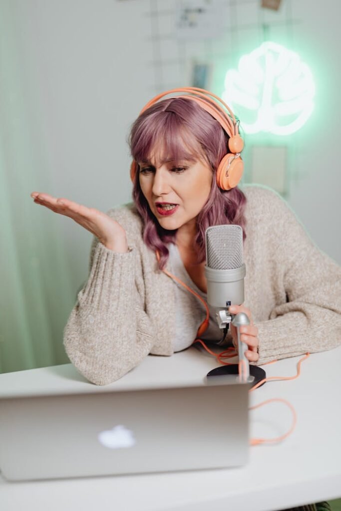 A Woman Talking on a Microphone while Wearing a Headphone